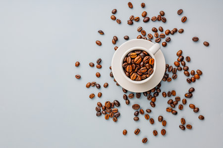 Roasted coffee beans in a coffee cup on the gray background. Top view.の写真素材