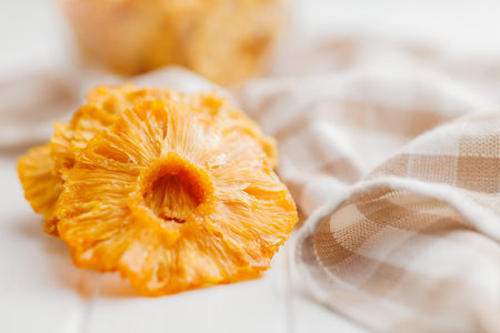 Dried pineapple rings on the white table.の写真素材