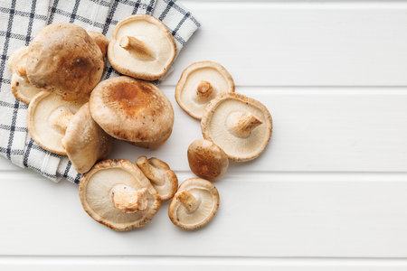 The fresh shiitake mushrooms on the white table. Top view.の写真素材