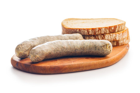 White pudding sausage. Pork product and bread on cutting board isolated on the white background.の写真素材