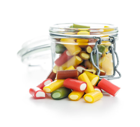Sweet colorful chewy candy sticks in a jar isolated on the white background.の写真素材