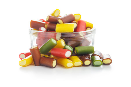 Sweet colorful chewy candy sticks in a jar isolated on the white background.の写真素材