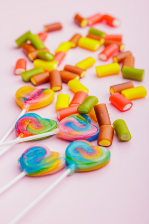 Colorful sweet jelly candies and lollipops on the pink background.の写真素材