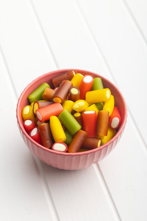 Colorful sweet jelly candies in a bowl on the white table.の写真素材