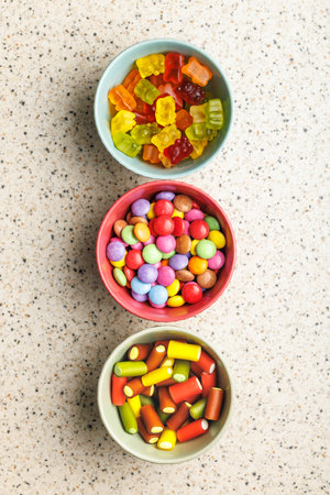 Colorful sweet jelly candies in a bowl on the kitchen table. Top view.の写真素材