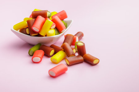 Colorful sweet jelly candies on the pink background.の写真素材