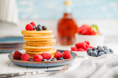 The homemade classic American pancakes with blueberries, raspberries and strawberries.の写真素材