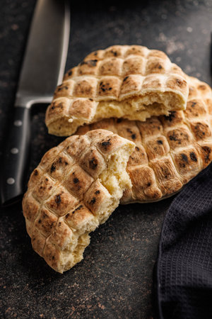 Arabic flat pita bread on the black table.