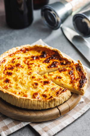 Traditional french pie. Quiche lorraine on the kitchen table.