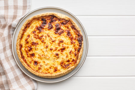 Traditional french pie. Quiche lorraine on the white table.の写真素材