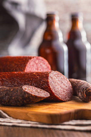Sliced salami sausage on cutting board on the kitchen table.の写真素材
