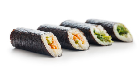A detailed view of sushi rolls, showcasing the various colorful ingredients tightly wrapped in seaweed and rice, set against a plain white background.の写真素材