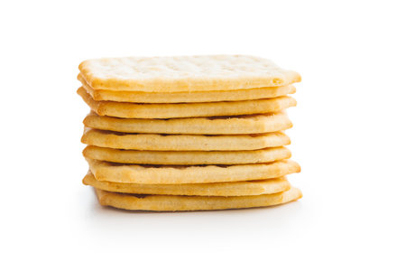 A pile of crackers stacked on a plain white surface. Isolated on white background.