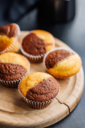 Close Up of a Muffins on a cutting board on a black table.の写真素材