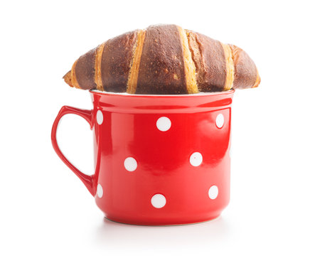 Fresh Chocolate Croissant With a Cup of Coffee on a White Backgroundの写真素材