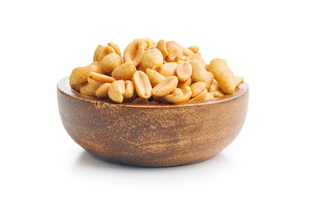 Salted roasted peanuts in a bowl isolated on a white background.の写真素材