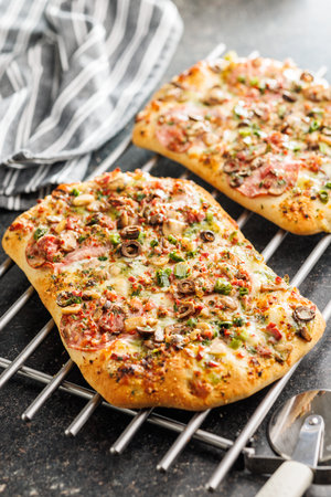 Tasty italian square pizza on a kitchen table.の写真素材