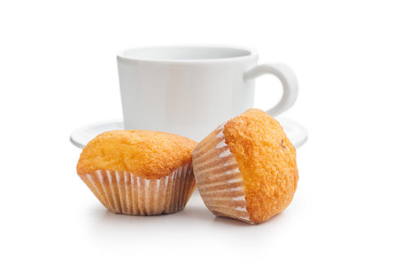 Magdalenas the typical spanish plain muffins and coffee cup isolated on a white background.の写真素材