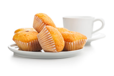 Magdalenas the typical Spanish plain muffins on a plate isolated on a white background.の写真素材