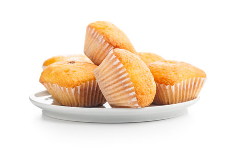 Magdalenas the typical Spanish plain muffins on a plate isolated on a white background.の写真素材