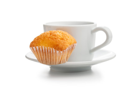 Magdalenas the typical spanish plain muffins and coffee cup isolated on a white background.の写真素材