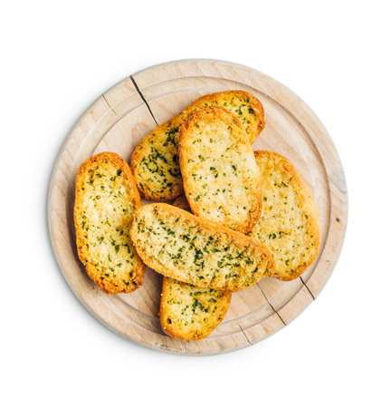 Garlic crisp bread Slices Topped With Herbs on cutting board isolated on a white background.の写真素材
