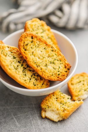 Garlic crisp bread Slices Topped With Herbs in a bowl.の写真素材