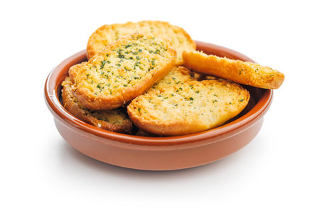 Garlic crisp bread Slices Topped With Herbs in bowl isolated on a white background.の写真素材