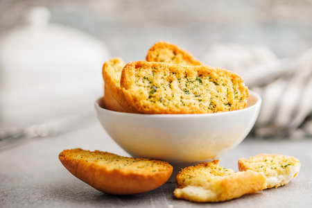 Garlic crisp bread Slices Topped With Herbs in a bowl.の写真素材