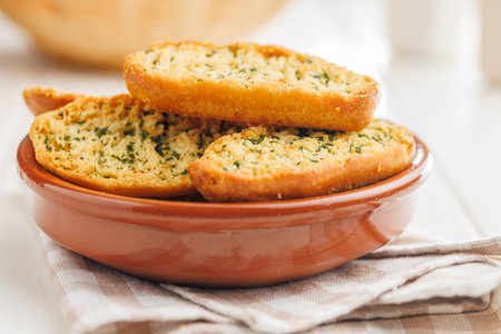 Garlic crisp bread Slices Topped With Herbs in a bowl.の写真素材