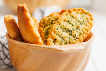 Garlic crisp bread Slices Topped With Herbs in a bowl.の写真素材