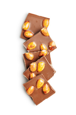 Broken chocolate bar with almonds isolated on a white background.の写真素材
