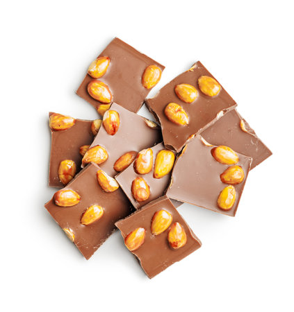 Broken chocolate bar with almonds isolated on a white background.の写真素材