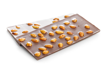 Chocolate bar with almonds isolated on a white background.の写真素材