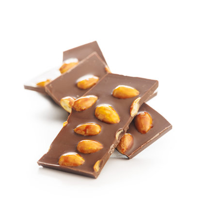 Broken chocolate bar with almonds isolated on a white background.の写真素材