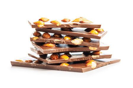 Broken chocolate bar with almonds isolated on a white background.の写真素材