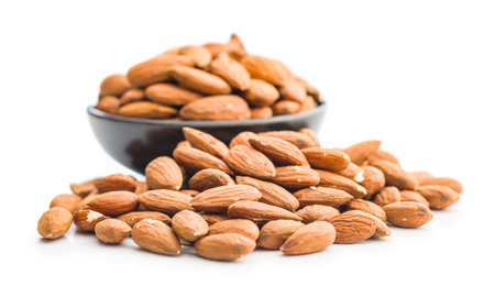 Peeled almond nuts in bowl isolated on a white background.の写真素材