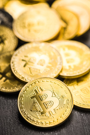 Bitcoin gold coin on a black table.の写真素材