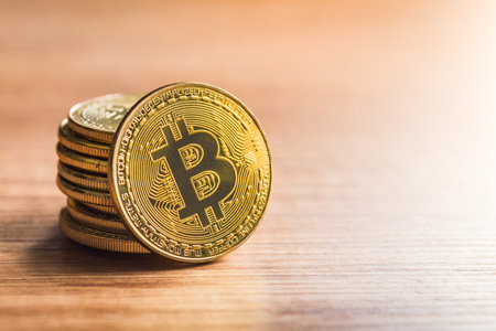 Bitcoin gold coin on a wooden table.の写真素材