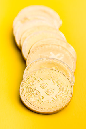Bitcoin gold coin on the yellow background.の写真素材