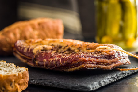 Smoked and Cured Pork Belly With Caraway Seeds on a Cutting Board.の写真素材