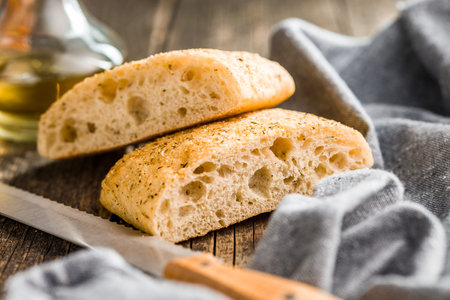 Italian ciabatta bread on a wooden table.の写真素材