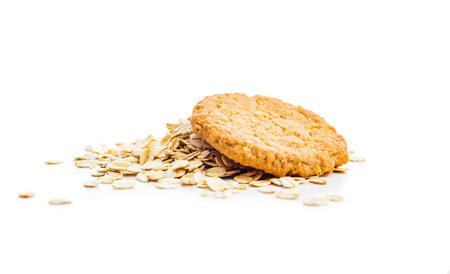 Tasty oatmeal cookies and rolled oat isolated on a white background.の写真素材