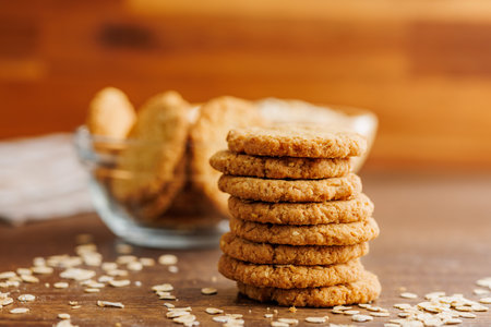 Tasty oatmeal cookies and rolled oat on a wooden table.の写真素材