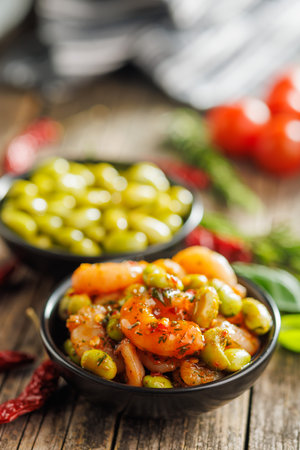 Fresh salad with shrimps and edamame soybeans in a bowl on a wooden table.の写真素材