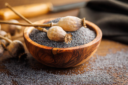 Dry head and poppy seed in bowl on a kitchen table.の写真素材