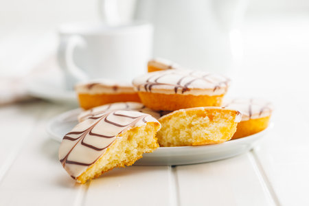 Sweet dessert with sugar coating on a plate on a white table.の写真素材