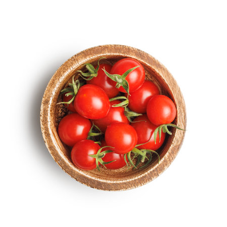 Small red cherry tomatoes in a bowl isolated on a white background.の写真素材