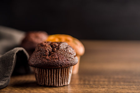 Sweet muffin cakes on a wooden table.の写真素材