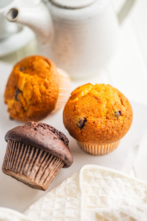 Sweet muffin cakes on a white table.の写真素材